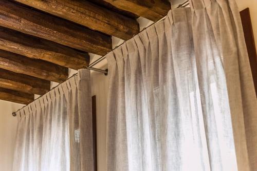 a curtain in a room with a window at Charming Palace Corte del Teatro in Venice