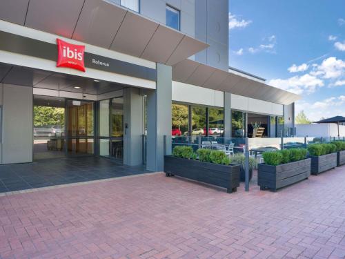 a building with aubs sign on the side of it at ibis Rotorua in Rotorua