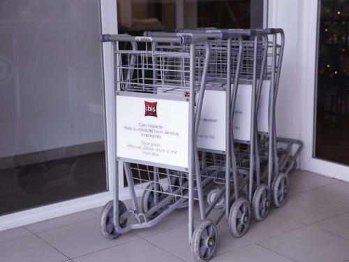 a group of shopping carts sitting in front of a window at ibis Recife Boa Viagem in Recife