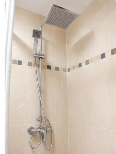 a shower with a shower head in a bathroom at Luna house in Zaragoza