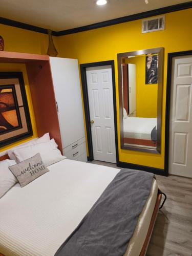 a bedroom with a bed and a mirror at Houston Sweet Spot Townhouse in Houston
