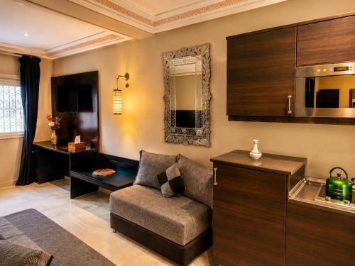 a living room with a chair and a mirror at Palais Riad Reda & Spa in Fez