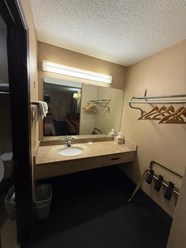 a bathroom with a sink and a mirror at America's Best Inn & Suites Eureka in Eureka