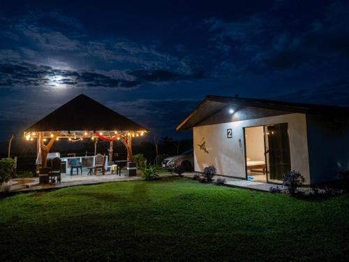 a small house with a patio at night at Hills Villa Rio Celeste in Rio Celeste