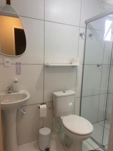 a bathroom with a toilet and a sink and a shower at Apartamento Flores do Bosque in Garanhuns