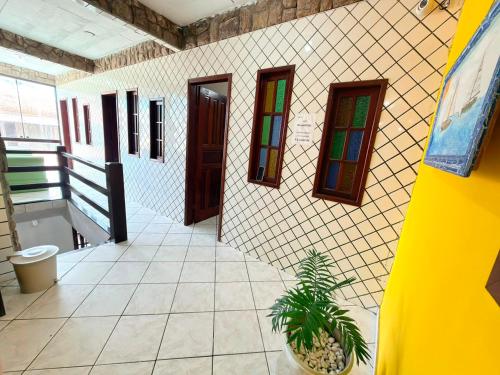 a bathroom with a potted plant and stained glass windows at Pousada Azul do Mar by BlueOcean in Arraial do Cabo