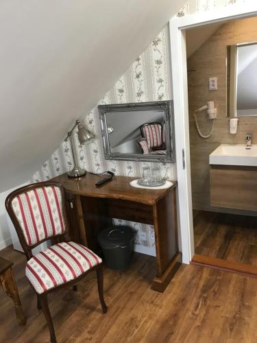 a bathroom with a desk with a mirror and a sink at CenterCity Apartments in Prešov