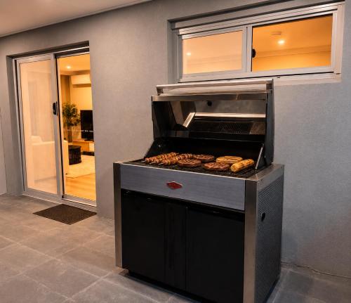 a grill with some food on top of it at Bayview Luxe Retreat in Tascott