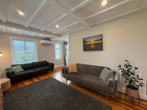 a living room with two couches and a couch at Maison Millie - Central Pet-Friendly Sleeps 4 in Rotorua