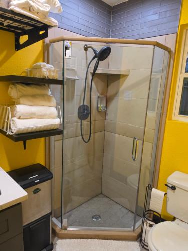 a shower with a glass door in a bathroom at Houston Sweet Spot Townhouse in Houston