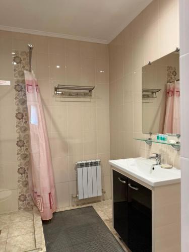 a bathroom with a sink and a shower at Saty Guest House in Saty