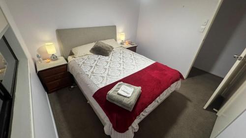 a small bedroom with a bed and two night stands at Cozy Quiet Beach room R2 in Brighton