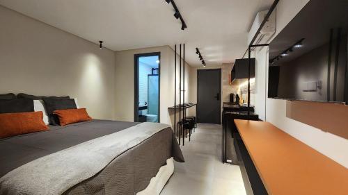 a bedroom with a bed and a desk and a television at Flat Praiano Intermares Boutique in Cabedelo