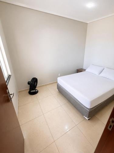 a bedroom with a white bed and a tiled floor at Galante in Toledo