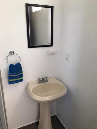 a bathroom with a sink and a mirror on the wall at Beautiful Apartment Executive 3 in Guadalupe