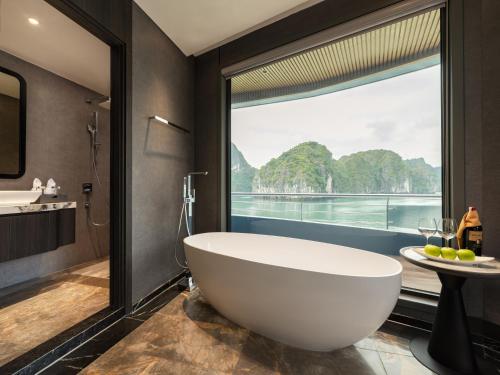 a bathroom with a large tub and a large window at M'Gloria Cruise by HAG in Ha Long