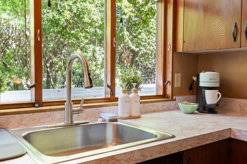 a kitchen counter with a sink and a window at Design-Forward | Steps to Shops & Dining | 2 Kings in Mill Valley