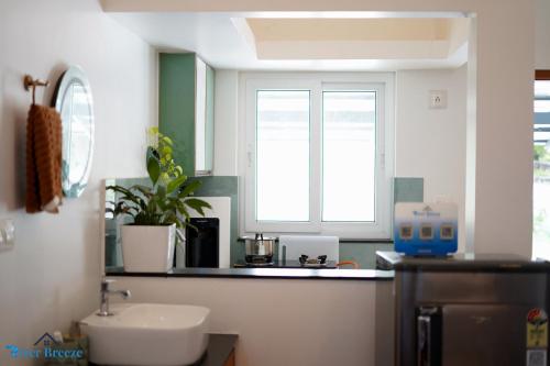 a kitchen with a sink and a window at River Breeze Cherai in Cochin