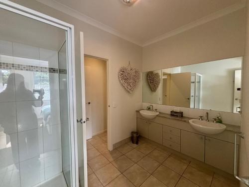 a bathroom with two sinks and a shower at Sandpiper 10 - Close to Town and Beach in Inverloch
