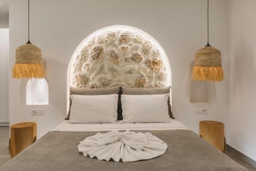 a bedroom with a bed with a large window at Zante Fiore Suites in Xirokástellon