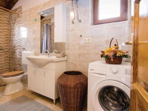 a bathroom with a washing machine and a sink at Three bedroom Vila with Pool in Stankovci