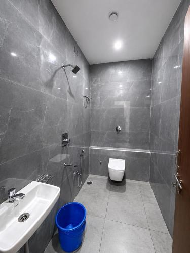 a bathroom with a sink and a toilet at Hotel Lavish Grand in Tenāli