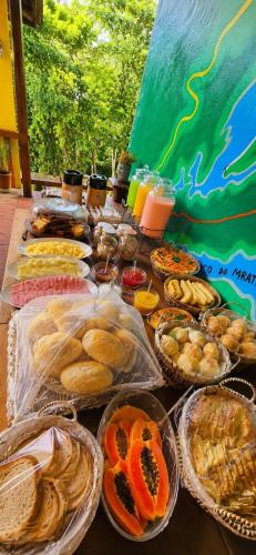 a table topped with lots of different types of food at Refúgio do Paraty Mirim in Paraty