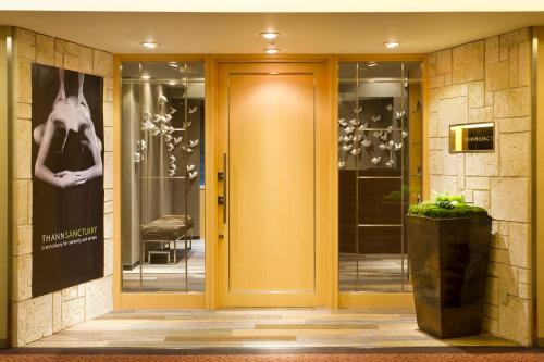 a front door of a building with a yellow door at ANA InterContinental Tokyo by IHG in Tokyo