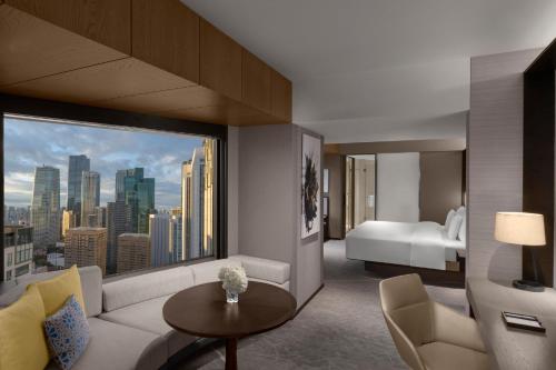 a living room with a couch and a large window at ANA InterContinental Tokyo by IHG in Tokyo