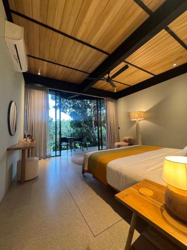 a bedroom with a large bed and a table at The Sevana in Talalla South
