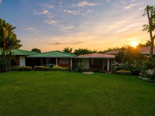 a house with a lawn in front of it at Chalet Natalia Montenegro Quindío in Montenegro