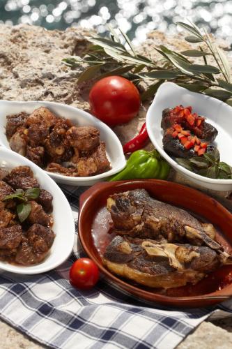 a table with plates of food on a table at Melpo Antia Hotel & Suites in Ayia Napa