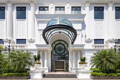 a white building with a clock on it at Meliá Vinpearl Tay Ninh in Tây Ninh
