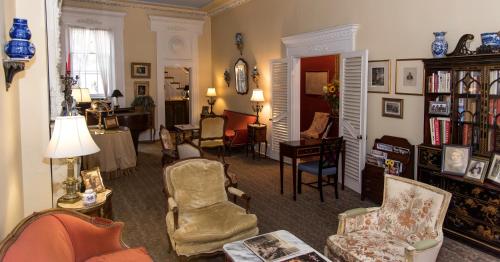 a living room filled with chairs and a table at La Reserve On Pine in Philadelphia