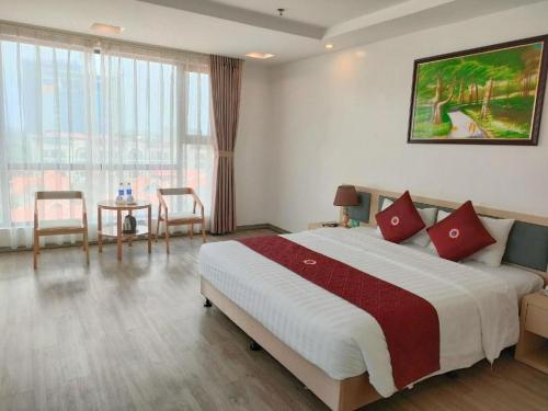 a bedroom with a large bed with red pillows at Smart Hotel in Bắc Ninh