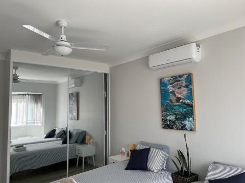a living room with a bed and a mirror at Large bedroom 2 King Single beds Centrally located in Jesmond