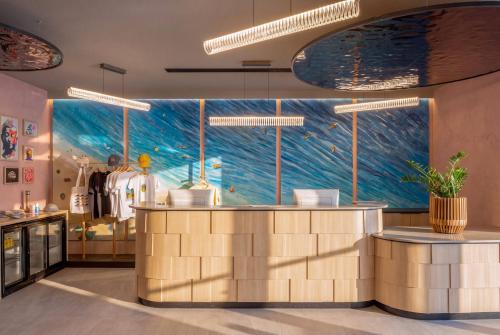 a restaurant with a large mural of the ocean at INNSiDE by Meliá Bugibba in St. Paul's Bay