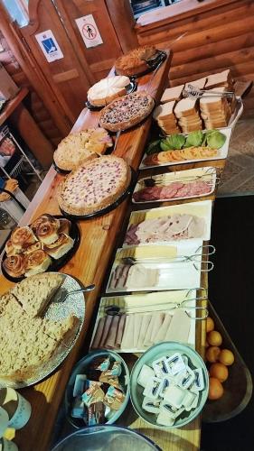 a buffet with many different types of bread and pastries at Cabañas Santa Maria Pucon in Pucón
