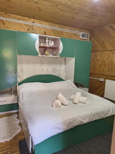 a bedroom with a bed with two towels on it at Casa Marco in Lepşa