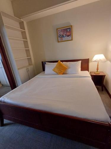 a bedroom with a large bed with two pillows at Home Time Square Residence in Kuala Lumpur