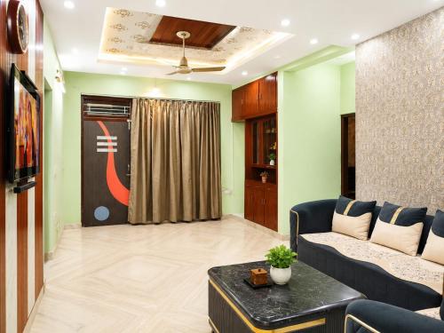 a living room with a couch and a table at Luxury Airy Retreat in Jaipur