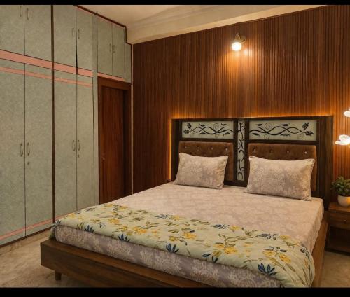 a bedroom with a large bed with two pillows at Luxury Airy Retreat in Jaipur