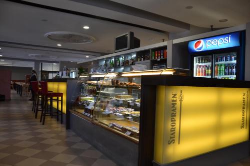 a restaurant with a counter with food and drinks at Motorest a Motel Rohlenka Austerlitz in Tvarožná