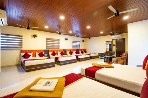 a living room with two beds and a couch at SREE Kumaran Residence in Rāmeswaram