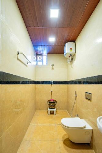 a bathroom with a toilet and a sink at SREE Kumaran Residence in Rāmeswaram