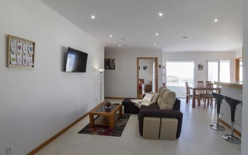 a living room with a couch and a table at Cantinho da Ilha in Achadinha