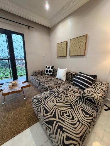 a living room with a bed and a couch at KameronStudio in Yaoundé