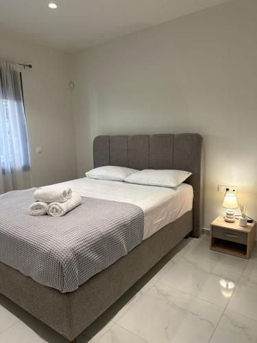 a bedroom with a bed with towels on it at Eleonora apartment in Porto Rafti