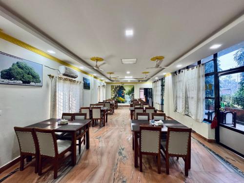 a row of tables and chairs in a restaurant at Hotel Buddha Palace in Rummindei