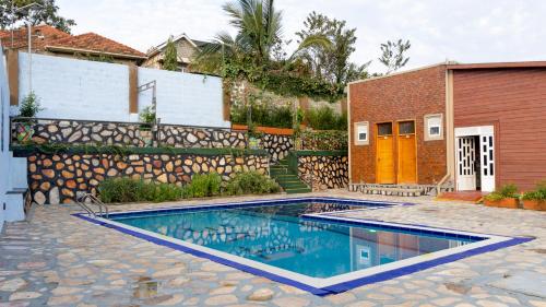 a swimming pool in front of a house at JET VILLAS ENTEBBE ( JVE ) in Entebbe